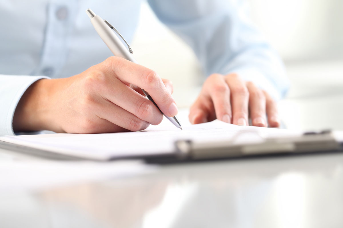 Woman's hands filling in form